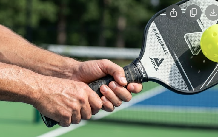 Player hitting a two-handed backhand in pickleball at the kitchen line